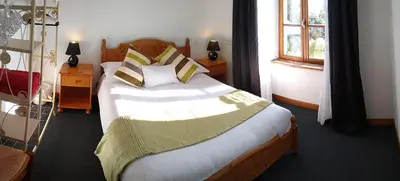 Un ou plusieurs lits dans un hébergement de l'établissement Le Jardin B&B