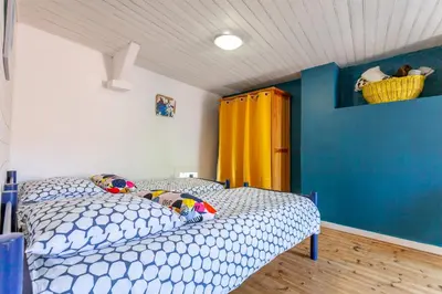 Un ou plusieurs lits dans un hébergement de l'établissement Cute Normandy Chaleureuse Maison au Cap Levi
