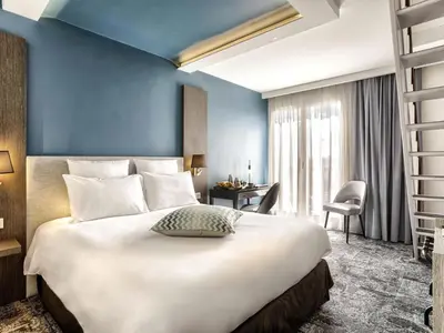 Un ou plusieurs lits dans un hébergement de l'établissement Mercure Cabourg Hôtel & Spa