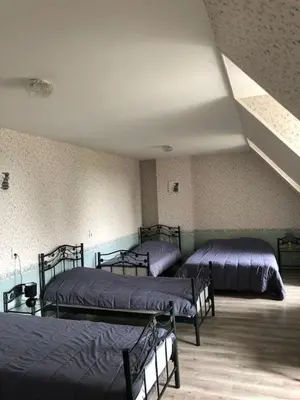 Un ou plusieurs lits dans un hébergement de l'établissement Gite Le Grand Manoir