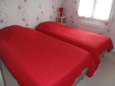 Un ou plusieurs lits dans un hébergement de l'établissement petite maison de vacance 2 chambres