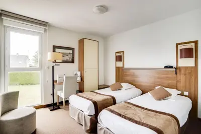 Un ou plusieurs lits dans un hébergement de l'établissement Brit Hotel De La Côte Des Havres
