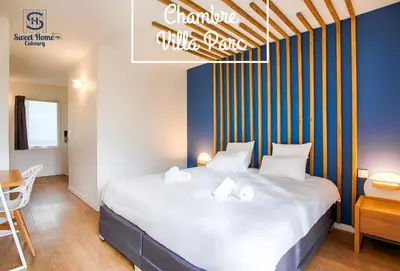 Un ou plusieurs lits dans un hébergement de l'établissement Sweet Home Cabourg Hôtel et gîtes