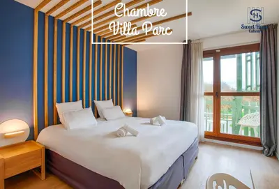 Un ou plusieurs lits dans un hébergement de l'établissement Sweet Home Cabourg Hôtel et gîtes