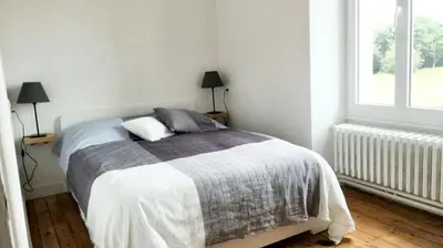 Un ou plusieurs lits dans un hébergement de l'établissement Maison cosy à Pontorson avec jardin clos et terrasse