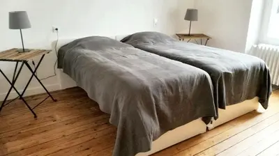 Un ou plusieurs lits dans un hébergement de l'établissement Maison cosy à Pontorson avec jardin clos et terrasse
