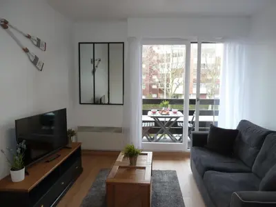 Coin salon dans l'établissement CABOURG APPARTEMENT EN RESIDENCE CALME ET COSI