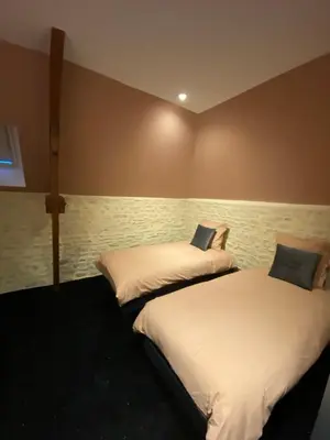 Un ou plusieurs lits dans un hébergement de l'établissement L'ATELIER DU VIEUX BOIS Spa