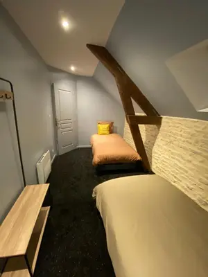 Un ou plusieurs lits dans un hébergement de l'établissement L'ATELIER DU VIEUX BOIS Spa