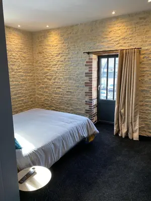 Un ou plusieurs lits dans un hébergement de l'établissement L'ATELIER DU VIEUX BOIS Spa