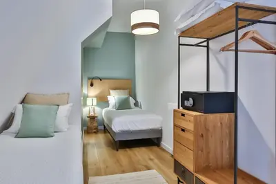 Un ou plusieurs lits dans un hébergement de l'établissement Hôtel & Spa FACE À LA MER