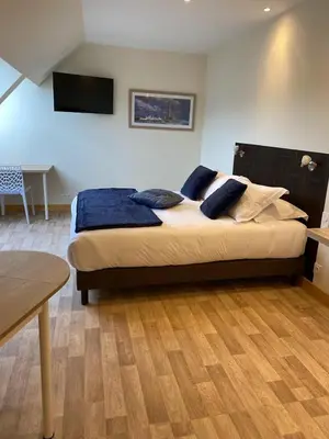 Un ou plusieurs lits dans un hébergement de l'établissement Le Rocher Appart Hôtel