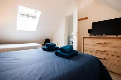 Un ou plusieurs lits dans un hébergement de l'établissement Maison comprenant deux gîtes à louer, ensemble ou indépendamment, capacité de 4 à 19 personnes Idéalement placé pour visiter le Mont-Saint-Michel, Saint-Malo et les alentours