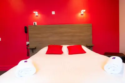 Un ou plusieurs lits dans un hébergement de l'établissement Logis Hotel Du Chateau