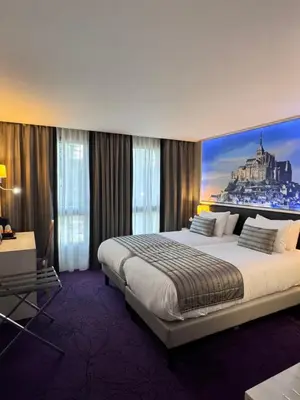Un ou plusieurs lits dans un hébergement de l'établissement Churchill Hotel Bayeux Centre