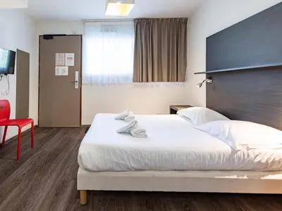 Un ou plusieurs lits dans un hébergement de l'établissement Vacancéole - Les Chambres de la Baie