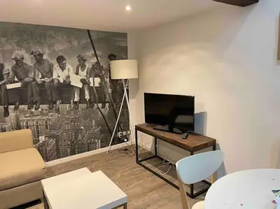 Télévision ou salle de divertissement dans l'établissement Ambre, bel appartement proche plage du débarquement