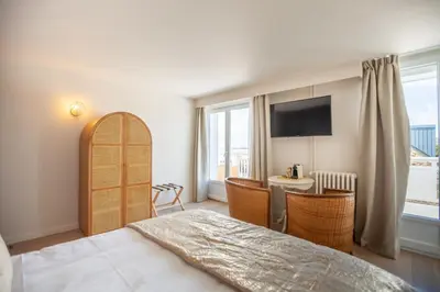 Un ou plusieurs lits dans un hébergement de l'établissement Hôtel des Isles