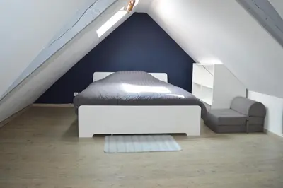 Un ou plusieurs lits dans un hébergement de l'établissement Halte Lutine - Maison chaleureuse en pierres