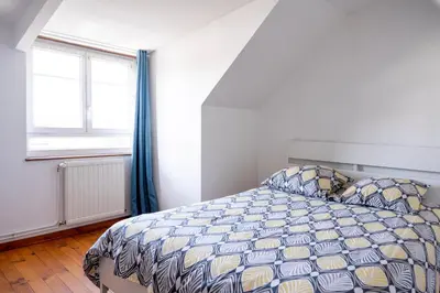 Un ou plusieurs lits dans un hébergement de l'établissement Grand appartement spacieux sur les toits de Bayeux