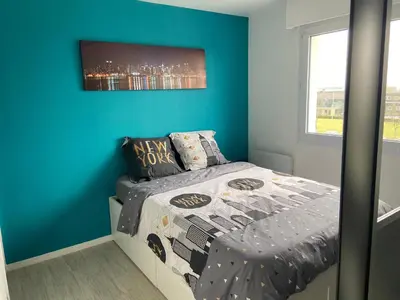 Un ou plusieurs lits dans un hébergement de l'établissement Grand Studio Lumineux Caen Memorial