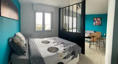Un ou plusieurs lits dans un hébergement de l'établissement Grand Studio Lumineux Caen Memorial