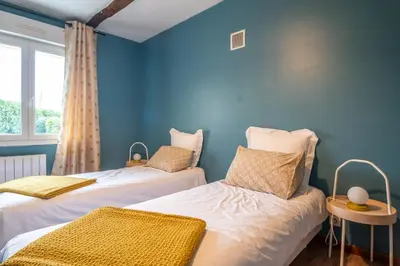 Un ou plusieurs lits dans un hébergement de l'établissement L'Îlot Pomme Cottage