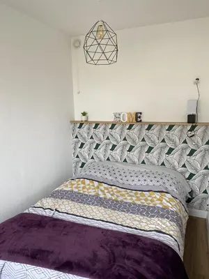 Un ou plusieurs lits dans un hébergement de l'établissement Super appartement cosy, parking privé