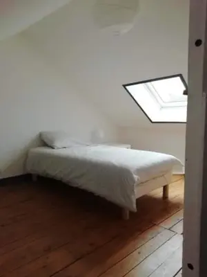 Un ou plusieurs lits dans un hébergement de l'établissement Maison de vacances vaux sur seulles