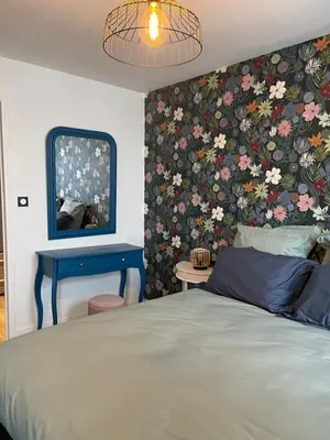 Un ou plusieurs lits dans un hébergement de l'établissement Le Trois Fleurs