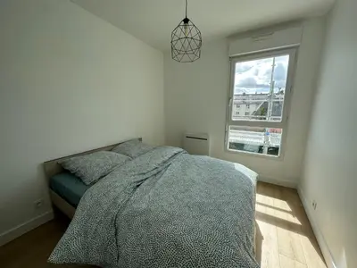 Un ou plusieurs lits dans un hébergement de l'établissement Appartement Caen