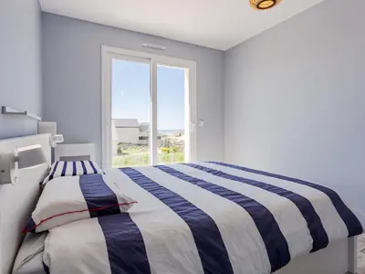 Un ou plusieurs lits dans un hébergement de l'établissement Holiday Home Paradis des Dunes by Interhome